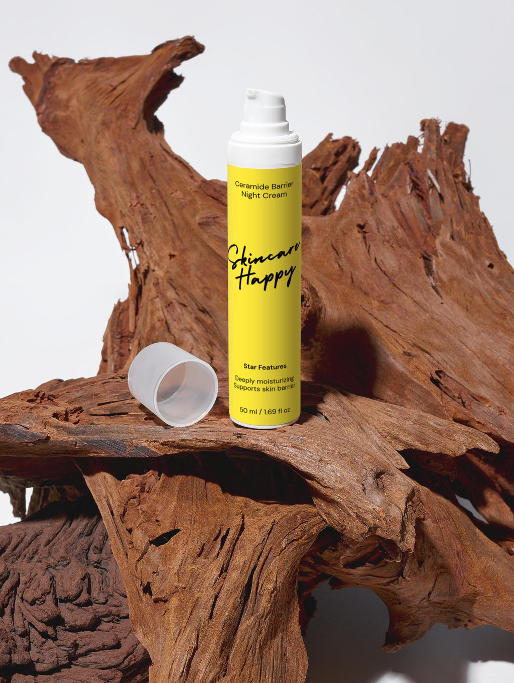 Yellow bottle of skincare product on a wooden surface