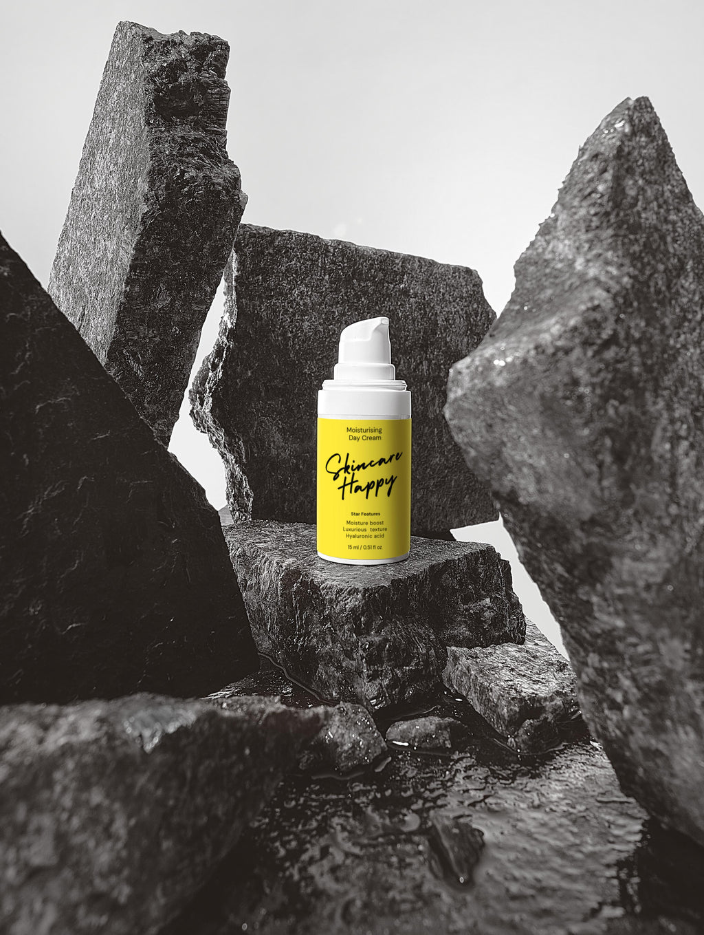 Yellow spray bottle with black text on a gray stone background